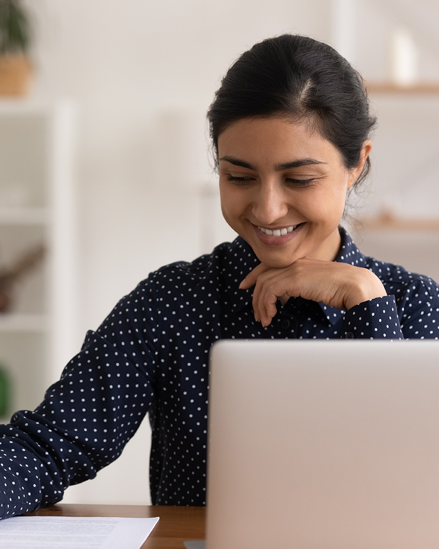 South Asian woman in front of a laptop getting online therapy for BPD in Glendale, NY